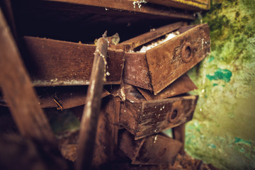 Close up focus view of ruined old forgotten wooden furniture in the abandoned deserted house.