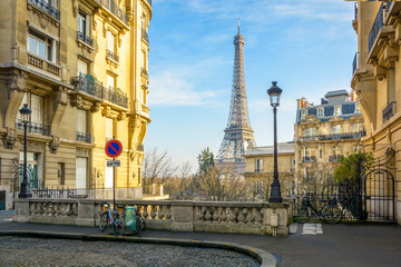 View of the Eiffel Tower from a small cobbled dead-end street of the Chaillot hill by a sunny...