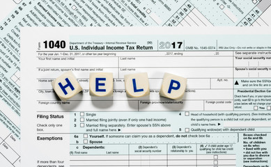 Macro close up of 2017 IRS form 1040 with HELP letters