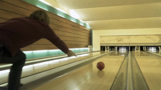 Man throws bowling ball, camera follows after the ball