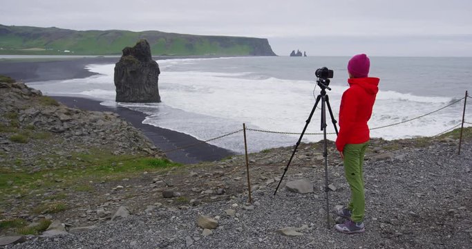 Landscape travel photographer photographing nature on Iceland in Dyrholaey with view of Reynisfjara beach near Vik, South Iceland. Shot on RED EPIC in SLOW MOTION.