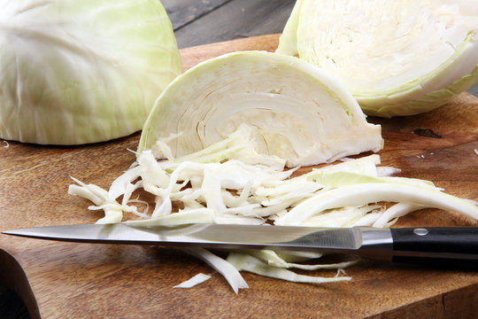 Shredded cabbage, white cabbage on wooden cutting board