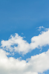 The vertical view of light blue sky with white clouds for background or texture. Copy space