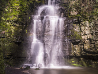 Swallet Waterfall In Peak District in Sunlight with Contrasting Rocks