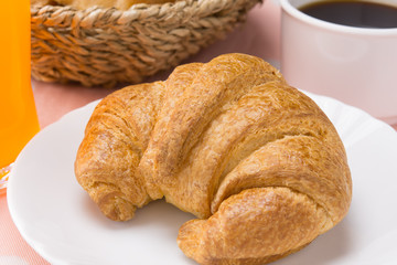 closed up fresh croissant on white dish