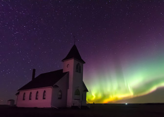 Northern Lights Aurora Borealis over a prairie church established in 1919 near Cabri, Saskatchewan, Canada