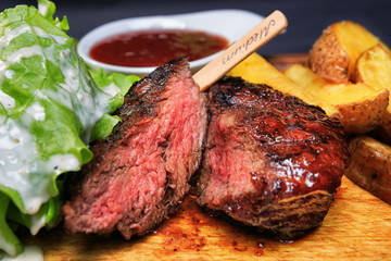 Beef steak with french fries and lettuce