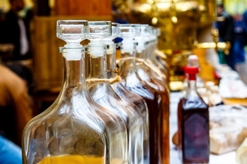 Transparent bottles of different alcoholic beverages - cordials and liqueurs.
