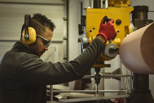 Male worker operating a machine