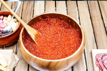 Red salmon caviar in a large bowl.