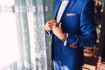 A successful businessman or groom wearing an expensive blue jacket.