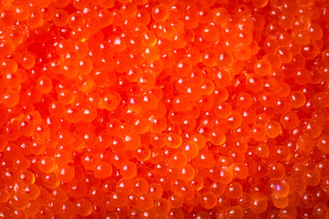 Raw salmon/trout fish eggs. Close up red caviar sea food pattern
