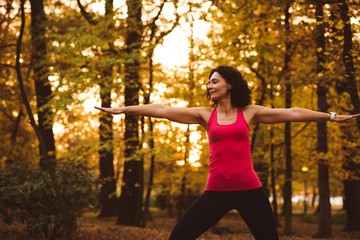 Woman performing exercise in forest 