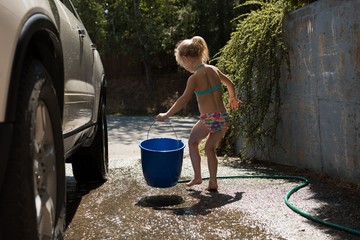 Girl holding blue bucket