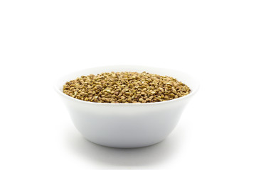 Dry buckwheat in white ceramic bowl isolated on white