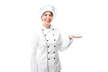 Pretty chef holding an empty plate