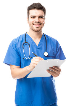 Male Nurse Reading A Medical Chart