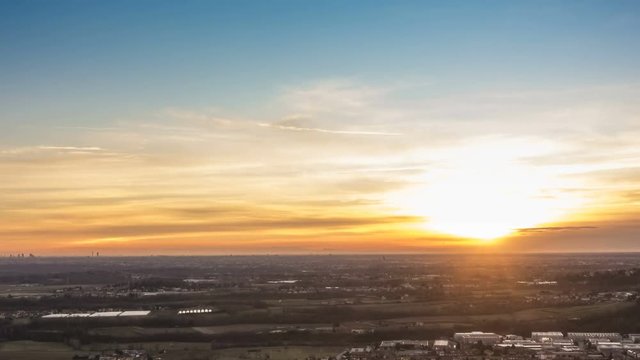 Timelapse of Milan city area and Po Valley, Italy at sunset from day to night. Aerial View