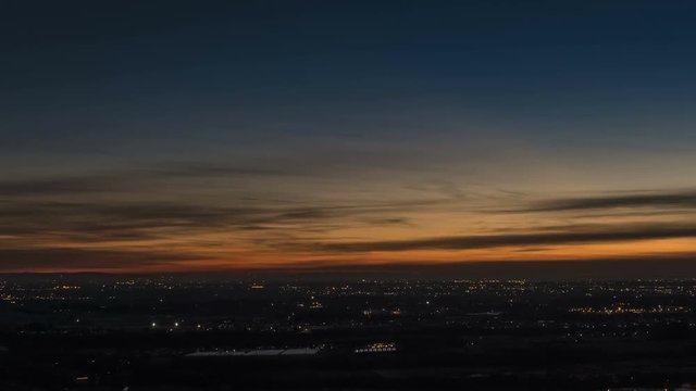 Timelapse of Milan city area and Po Valley, Italy at sunset from day to night. Aerial View