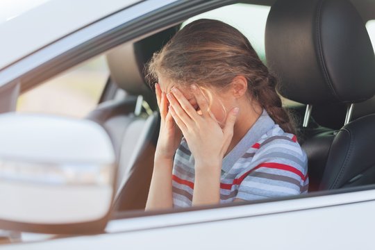 Portrait Of Young Woman Crying In Her Car