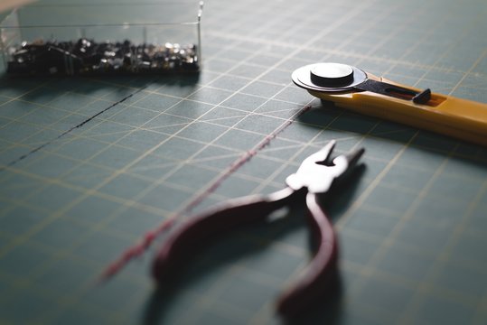 Pliers and blade on table 