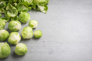 Brussel sprouts and peels on a stone background.