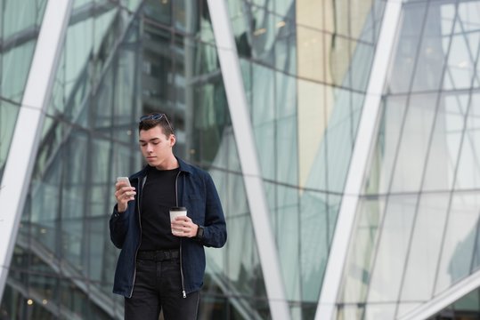 Man using mobile phone while having coffee