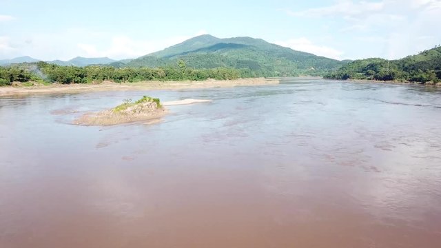 An aerial view from a drone of Mekong river, rain forest and mountains in Thailand and Laos
