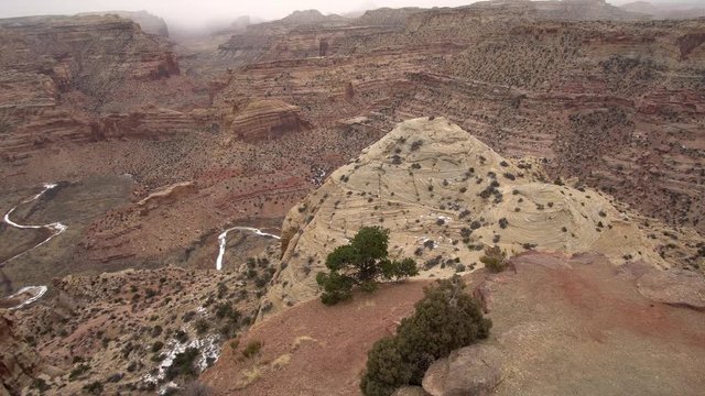 Panning view from the Wedge overlook while it is snowing looking at the Little Grand Canyon in Utah.