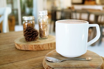 Cup of hot coffee on wooden table.