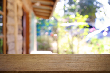 Empty wooden table in front of abstract blurred background of coffee shop . can be used for display or montage your products.Mock up for display of product.