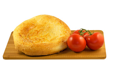 pita bread and tomatoes on wooden board isolated on white background