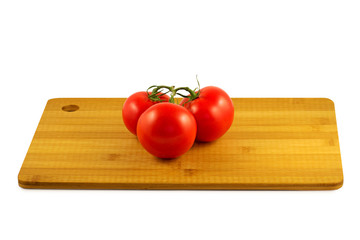 tomatoes on wooden board isolated on white background