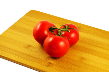 tomatoes on wooden board isolated on white background