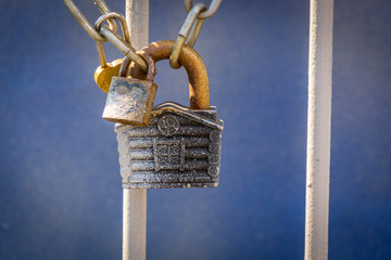 Beautiful closed padlock hanging on the iron fence