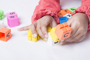 Kid's hands plug and play the alphabets toys