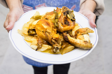 hands with pieces of roasted chicken