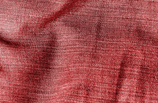 Jeans textile texture in red color.