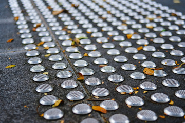 Metal tactile paving tiles for the blind.