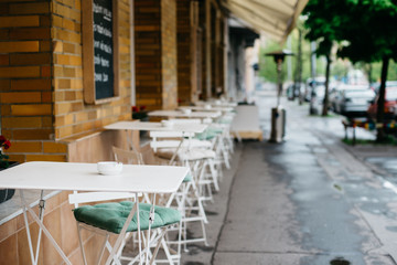 Cafe with empty tables and chairs outdoors