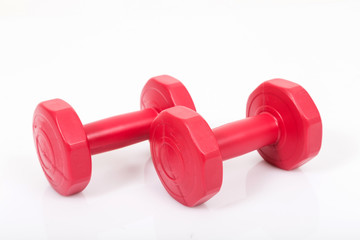 Obraz premium Red dumbells. Isolated on a White Background.