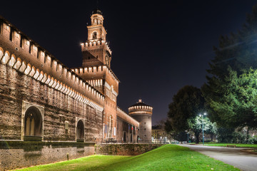 Milan, Italy. Public pedestrian path in front of the castello Sforzesco (Sforza Castle) main entrance  (14 - 15th century),  in the evening. The sforza castle is one of the monuments symbol of Milan