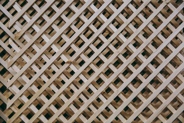 Background, diagonal wooden grille. Texture of the wooden lattice.