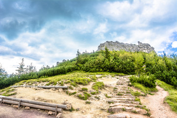 Fototapeta na wymiar Rocky mountain above hiking trail, view on rocks on top of mountains, landscape