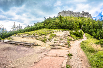 Hiking trail in mountains, landscape, path with rocks leading to the peak of mountain