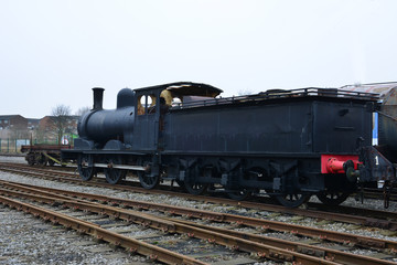 Fototapeta premium An old steam locomotive left in a railway siding in the UK.
