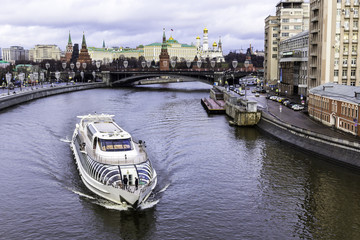 View of the Kremlin from the Patriarchal bridge. A thaw in the mid-winter. A sightseeing ship on...