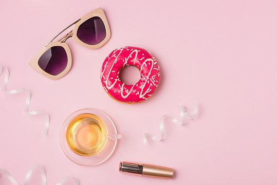 Delicate pink party background for celebrating accessories and donut.