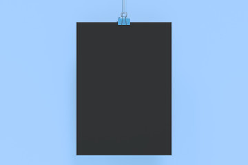 Blank black poster with binder clip mockup on blue background
