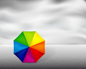 Colored umbrella on gray background